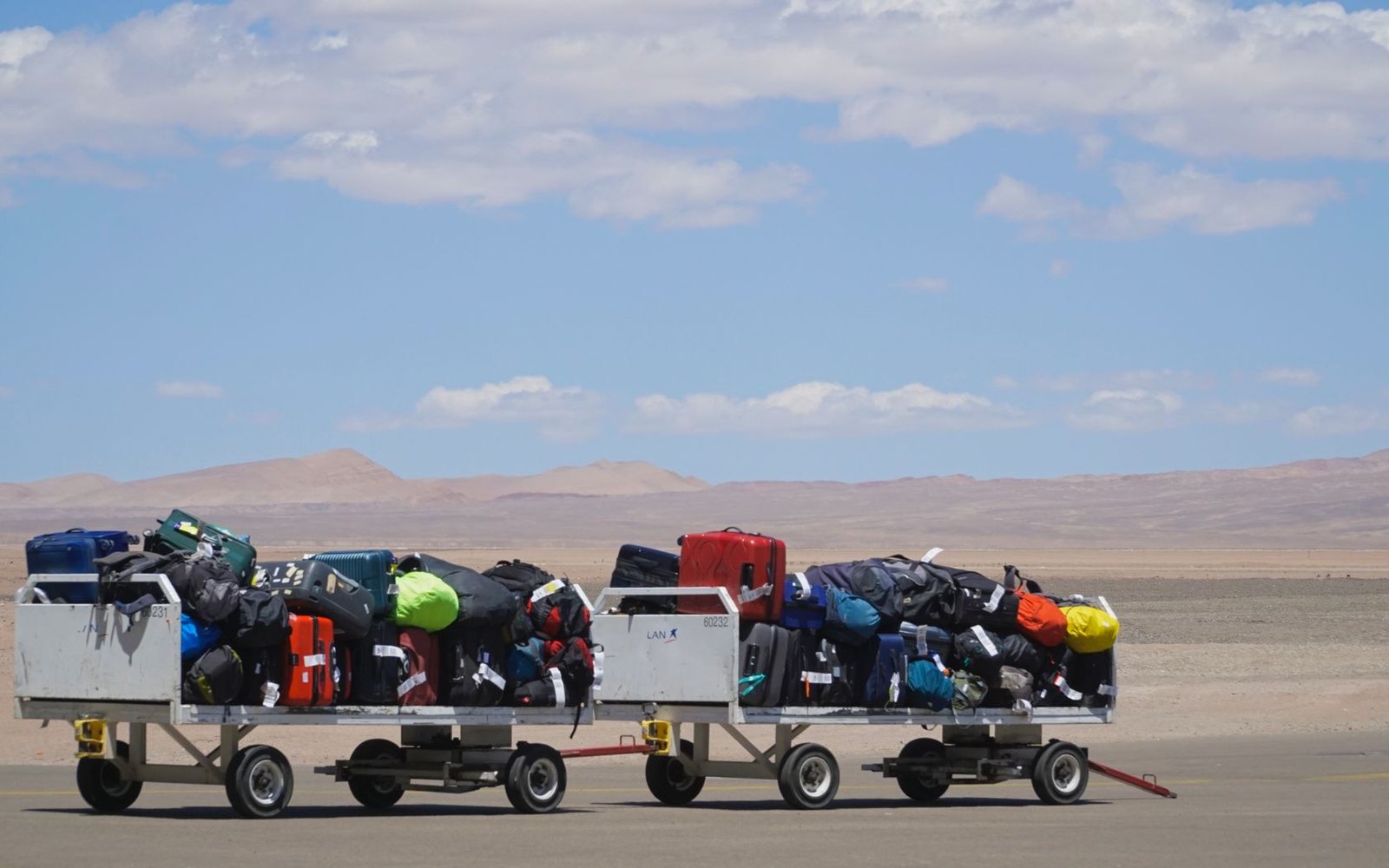 Carry-on luggage and travel bags being organized at an airport for Trip Gear Scout route checks